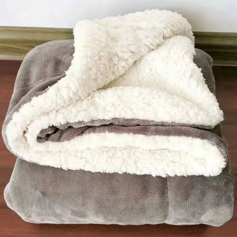 Ultra soft sherpa fleece blanket folded on bed providing cozy warmth and comfort